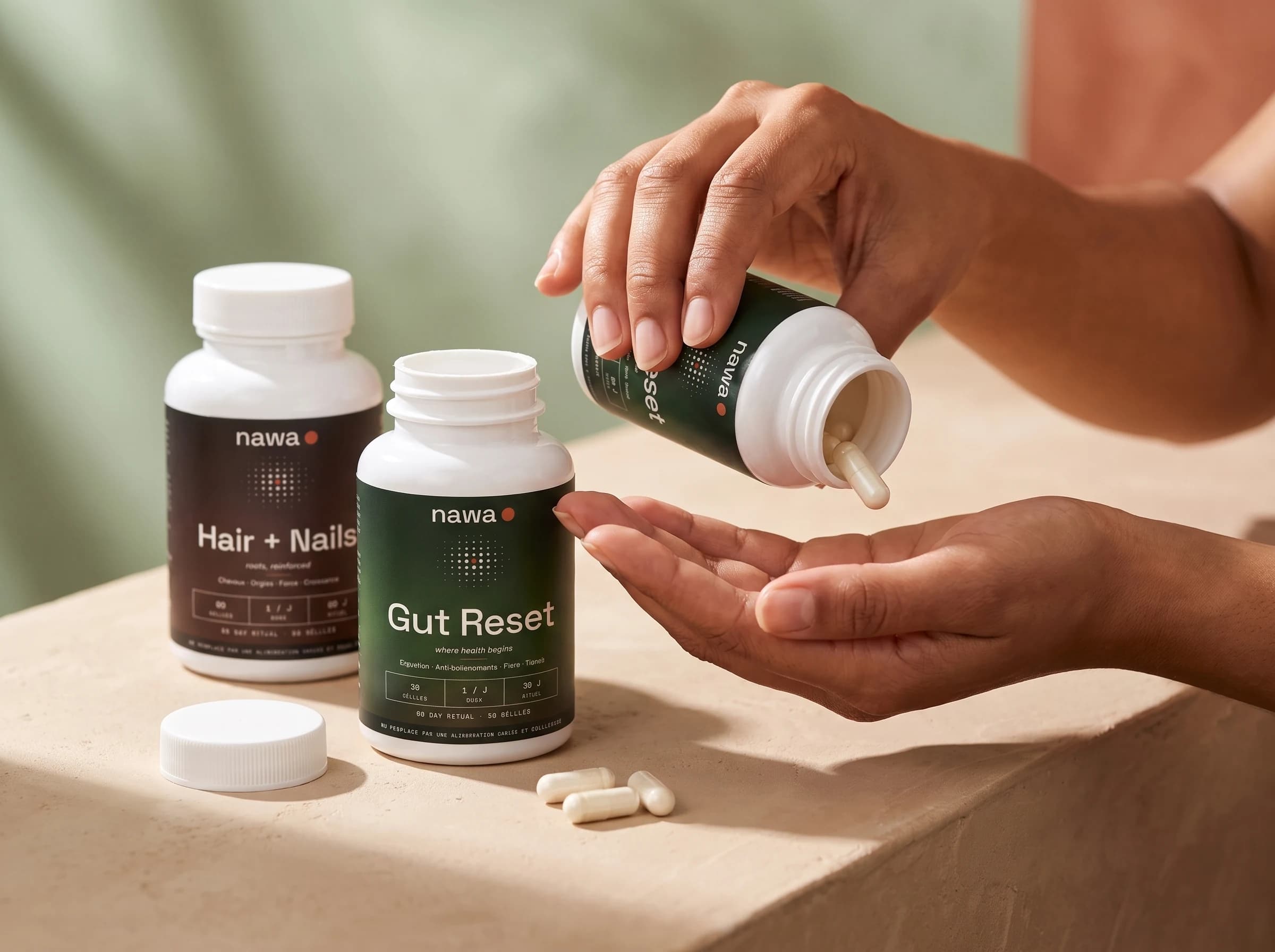 NAWA ritual — a hand pouring out a capsule, both bottles